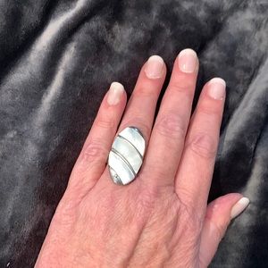 Costume jewelry large statement ring silver tone w opalescent center.Adjusts 8